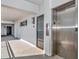 Exterior entry of a condo building featuring secure key access and elevator at 226 Golden Gate Pt # 64, Sarasota, FL 34236