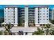 Stylish condo building with multiple balconies overlooking lush greenery, and well-maintained surroundings at 226 Golden Gate Pt # 64, Sarasota, FL 34236