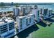 Aerial view of modern waterfront condos, showcasing the building's sleek design at 226 Golden Gate Pt # 64, Sarasota, FL 34236