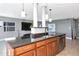 Well-designed kitchen island with dark granite countertops, custom cabinetry, and a stainless steel dishwasher at 226 Golden Gate Pt # 64, Sarasota, FL 34236