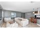 Well-appointed living room featuring comfortable seating, modern artwork, and a breakfast bar at 226 Golden Gate Pt # 64, Sarasota, FL 34236