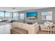 Comfortable living room showcasing modern decor, a large screen TV, and bay views at 226 Golden Gate Pt # 64, Sarasota, FL 34236
