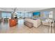 Open-concept living room featuring a large TV, modern furnishings, and lots of natural light at 226 Golden Gate Pt # 64, Sarasota, FL 34236