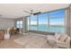 Inviting living room with floor-to-ceiling windows offering views of the bay at 226 Golden Gate Pt # 64, Sarasota, FL 34236