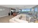 Expansive living space featuring a modern kitchen, comfortable seating, and floor-to-ceiling windows with scenic views at 226 Golden Gate Pt # 64, Sarasota, FL 34236