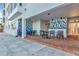Outdoor patio space with tables and chairs and designer tile at 226 Golden Gate Pt # 64, Sarasota, FL 34236