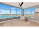 Cozy sitting area featuring floor-to-ceiling windows showcasing waterfront views at 226 Golden Gate Pt # 64, Sarasota, FL 34236