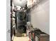 Walk-in storage area with stacked washer and dryer and wire shelving at 226 Golden Gate Pt # 64, Sarasota, FL 34236