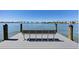 Picturesque waterfront view from the dock featuring a bench and a beautiful bay at 226 Golden Gate Pt # 64, Sarasota, FL 34236