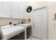 Bright laundry room with Maytag washer and dryer, and ample storage at 7565 Palmer Glen Cir, Sarasota, FL 34240