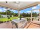 Screened porch with lake view and outdoor furniture at 7565 Palmer Glen Cir, Sarasota, FL 34240