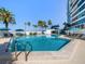 Stunning pool with plenty of lounge chairs and umbrellas at 988 Blvd Of The Arts # 810, Sarasota, FL 34236