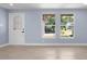 Bright living room with large windows and light blue walls at 6912 Kenwood Dr, North Port, FL 34287