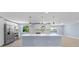 Modern kitchen with white cabinets, quartz countertops, and stainless steel appliances at 6912 Kenwood Dr, North Port, FL 34287