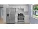 Modern kitchen with stainless steel appliances and white cabinets at 6912 Kenwood Dr, North Port, FL 34287