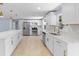 Open concept kitchen boasts stainless steel appliances and an island at 6912 Kenwood Dr, North Port, FL 34287
