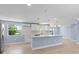 Modern kitchen with white cabinets, quartz countertops, and a large island at 6912 Kenwood Dr, North Port, FL 34287