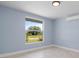 Bedroom with yard view and wall mounted AC unit at 6912 Kenwood Dr, North Port, FL 34287