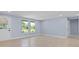 Spacious living room with light blue walls and tile flooring at 6912 Kenwood Dr, North Port, FL 34287