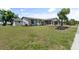 Single story home with a large grassy yard at 6912 Kenwood Dr, North Port, FL 34287