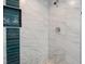 Spa-like shower with marble and teal tile accents at 6912 Kenwood Dr, North Port, FL 34287