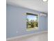 Bedroom with water view and wall mounted AC unit at 6912 Kenwood Dr, North Port, FL 34287