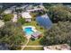 An aerial view of a community pool near a lake at 3384 Ramblewood Ct # B30E3, Sarasota, FL 34237