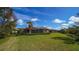 Private backyard with screened patio, lush landscaping, and lake view at 14636 Newtonmore Ln, Lakewood Ranch, FL 34202