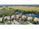 Luxury home nestled on a lake, with surrounding landscape and community at 14636 Newtonmore Ln, Lakewood Ranch, FL 34202