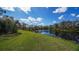 Beautiful lake view with lush green grass and trees at 14636 Newtonmore Ln, Lakewood Ranch, FL 34202
