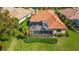 Home features a screened pool and spacious backyard with lush landscaping at 14636 Newtonmore Ln, Lakewood Ranch, FL 34202
