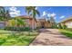 Inviting home exterior with tile roof, stone accents, and landscaped front yard at 14636 Newtonmore Ln, Lakewood Ranch, FL 34202