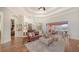 Open living room with hardwood floors, fireplace, and access to outdoor space at 14636 Newtonmore Ln, Lakewood Ranch, FL 34202