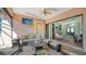 Covered patio with outdoor seating and views into the living room at 14636 Newtonmore Ln, Lakewood Ranch, FL 34202