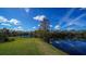 Serene lake view from the backyard with lush green grass at 14636 Newtonmore Ln, Lakewood Ranch, FL 34202