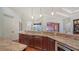 Large kitchen island with granite countertop and built-in appliances at 14636 Newtonmore Ln, Lakewood Ranch, FL 34202