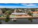 Aerial view of waterfront home with private beach and dock at 1903 Bayshore Dr, Belleair Beach, FL 33786