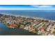 Aerial view highlighting home's beachfront location and canal access at 1903 Bayshore Dr, Belleair Beach, FL 33786