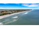 Aerial view of beach homes and coastline with beautiful ocean view at 1903 Bayshore Dr, Belleair Beach, FL 33786