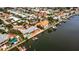 Wide aerial showcasing waterfront home in a residential neighborhood at 1903 Bayshore Dr, Belleair Beach, FL 33786