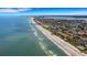 Aerial view of coastline with beautiful beach and ocean view at 1903 Bayshore Dr, Belleair Beach, FL 33786