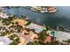 Aerial view of a waterfront home with a pool at 1903 Bayshore Dr, Belleair Beach, FL 33786