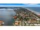 Wide aerial view of neighborhood, showcasing location near the water at 1903 Bayshore Dr, Belleair Beach, FL 33786