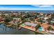 Aerial view of a waterfront home and neighborhood, near the ocean at 1903 Bayshore Dr, Belleair Beach, FL 33786