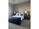 Cozy bedroom with a queen-size bed, nightstands, and ceiling fan at 5146 Northridge Rd # 209, Sarasota, FL 34238