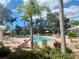 Relaxing community pool with lounge chairs and palm trees at 5146 Northridge Rd # 209, Sarasota, FL 34238