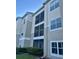Exterior view of condo building showcasing screened balconies at 5146 Northridge Rd # 209, Sarasota, FL 34238