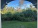Private backyard view with lush trees and greenery at 5146 Northridge Rd # 209, Sarasota, FL 34238
