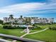 Aerial view of a condo community with lush landscaping, pool, and walkways at 1485 Gulf Of Mexico Dr # 201, Longboat Key, FL 34228