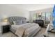 Main bedroom with king-size bed and large TV at 4658 Longwater Chase # 104, Sarasota, FL 34235